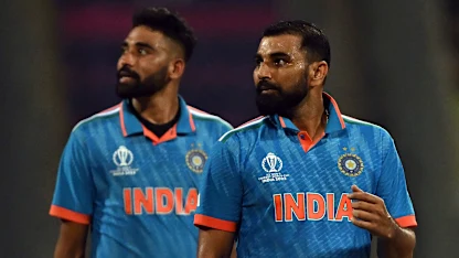 Logo of India's Mohammad Shami (R) and Mohammed Siraj look at the screen for replay after the dismissal of Sri Lanka's Dushan Hemantha