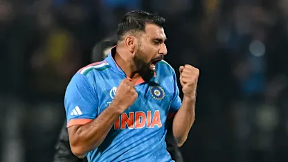 Logo of India's Mohammed Shami celebrates after taking the wicket of New Zealand's Matt Henry during the 2023 ICC Men's Cricket World Cup one-day international (ODI) match between India and New Zealand