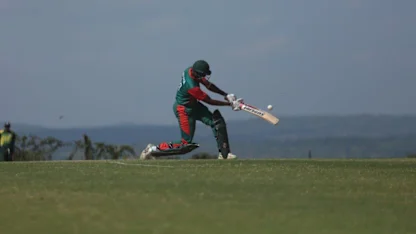 Logo of Collins Obuya powers a six for Kenya against Rwanda