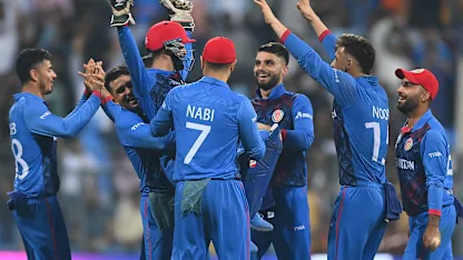 Logo of Rashid Khan of Afghanistan celebrates the wicket of Mitchell Starc of Australia during the ICC Men's Cricket World Cup India 2023 between Australia and Afghanistan
