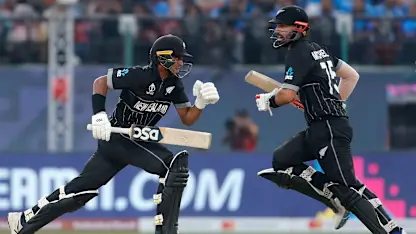 Logo of Daryl Mitchell (L) and Rachin Ravindra of New Zealand run between the wicket during the ICC Men's Cricket World Cup India 2023 match between India and New Zealand