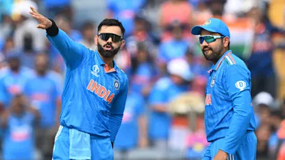 Logo of India's Virat Kohli (L) speaks with captain Rohit Sharma during the 2023 ICC Men's Cricket World Cup one-day international (ODI) match between India and Bangladesh