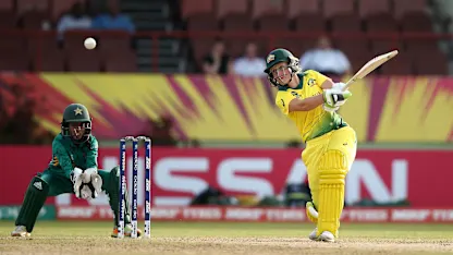 Logo of Alyssa Healy of Australia bats with Sidra Nawaz, wicket keeper of Pakistan looking on during the ICC Women's World T20 2018 match between Australia and Pakistan at Guyana National Stadium on November 9, 2018 in Providence, Guyana.