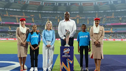 Ian Bishop carries the ICC Men's T20 World Cup Trophy