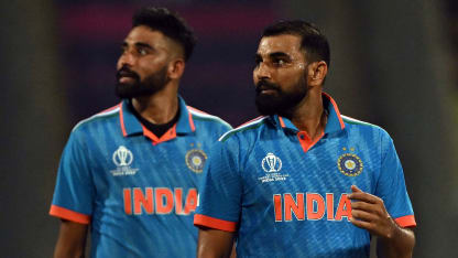 India's Mohammad Shami (R) and Mohammed Siraj look at the screen for replay after the dismissal of Sri Lanka's Dushan Hemantha