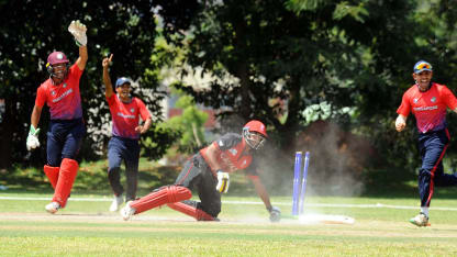 Singapore fielders appeal in their World Cricket League match against Singapore.