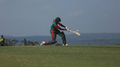 Collins Obuya powers a six for Kenya against Rwanda