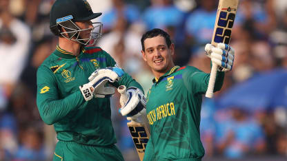 Quinton de Kock of South Africa celebrates their century with team mate Rassie van der Dussen during the ICC Men's Cricket World Cup India 2023 between New Zealand and South Africa