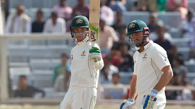 Peter Handscomb raising his bat after reaching his 50