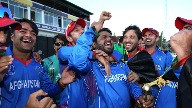 The winning Afghanistan team are lead in celebrations by Mohammed Shahzad (C) after The ICC Cricket World Cup Qualifier between Ireland and Afghanistan at The Harare Sports Club on March 23, 2018 in Harare, Zimbabwe (©ICC).