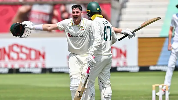 Matthew Renshaw of Australia celebrates his 100 with Nathan Lyon of Australia runs during day 2 of the 1st Dafabet Test match between South Africa and Australia at Hollywoodbets Kingsmead Stadium on October 10, 2026 in Durban, South Africa