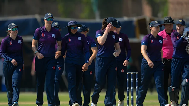 Scotland players celebrate after taking a wicket b