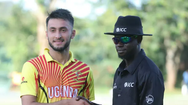 Player of the match Riazat Ali Shah receives his award from Nigerian umpire Kehinde Olanbiwonnu  (1)