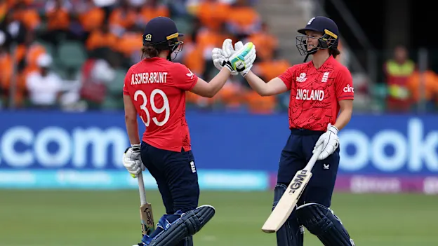 Nat Sciver-Brunt of England celebrates their half century with team mate Amy Jones during the ICC Women's T20 World Cup group B match between England and India at St George's Park on February 18, 2023 in Gqeberha, South Africa.