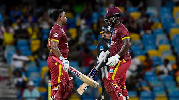 Shimron Hetmyer (L) and Sherfane Rutherford (R) of West Indies chat after reaching 50 runs partnership