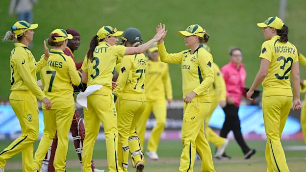 Jess Jonassen of Australia celebrates with teammate Megan Schutt after catching out Stafanie Taylor of the West Indies and to win the 2022 ICC Women's Cricket World Cup match between Australia and the West Indies at Basin Reserve on March 30, 2022.