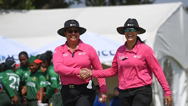 Match Umpires Kerrin Klaaste and Jasmine Naeem look on during the ICC Women's U19 T20 World Cup 2023 match between Bangladesh and USA at Willowmoore Park B Field on January 18, 2023 in Benoni, South Africa.