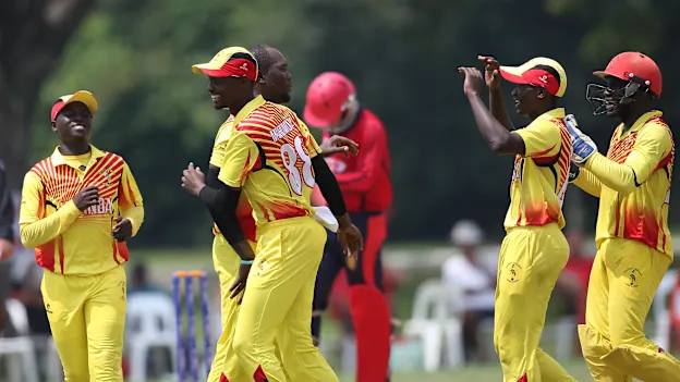 Uganda players celebrate the fall of a Jersey wicket
