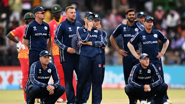 Players of Scotland watch the big screen during a review during the ICC Men's Cricket World Cup Qualifier Zimbabwe 2023 match between Zimbabwe and Scotland at Queen’s Sports Club on July 04, 2023 in Bulawayo, Zimbabwe.