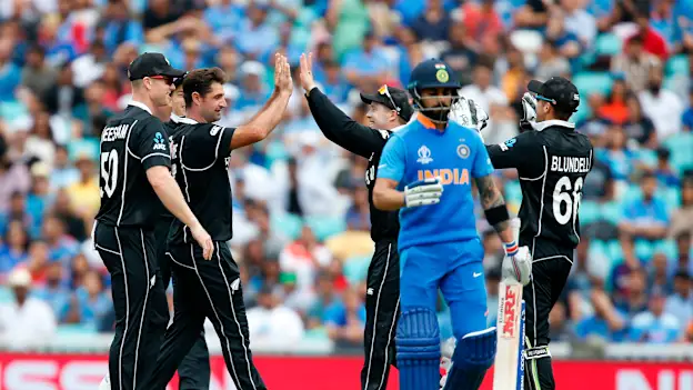 New Zealand's Colin de Grandhomme (2L) celebrates bowling India's Captain Virat Kohli (2R) for 18 runs during the 2019 Cricket World Cup warm up match between India and New Zealand at The Oval in London on May 25, 2019.