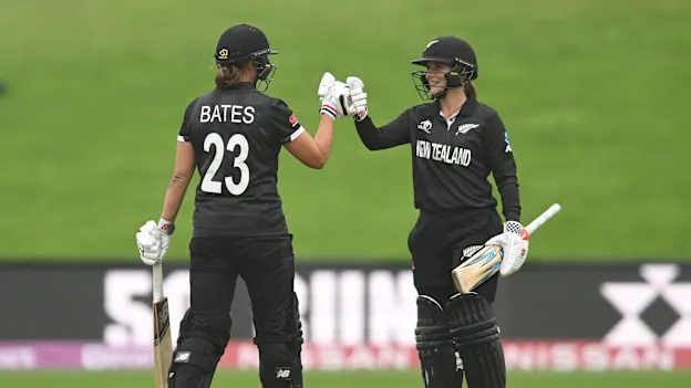 Suzie Bates of New Zealand is congratulated by teammate Amelia Kerr