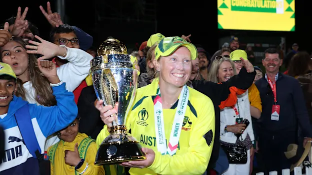 Alyssa Healy of Australia poses with the trophy in front of fans after Australia won the 2022 ICC Women's Cricket World Cup Final match between Australia and England at Hagley Oval on April 03, 2022 in Christchurch, New Zealand.