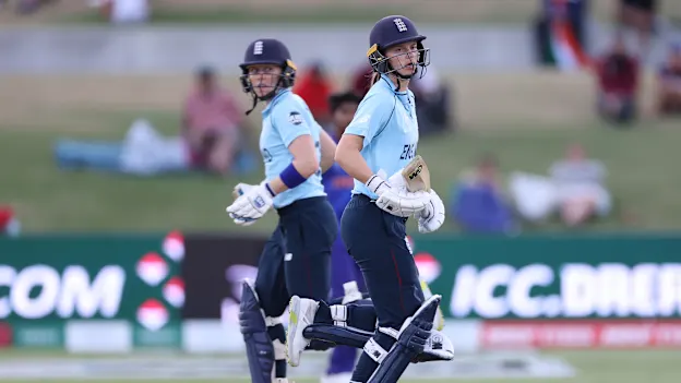 Amy Jones (R) and Heather Knight of England run between wickets during the 2022 ICC Women's Cricket World Cup match between England and India at Bay Oval on March 16, 2022 in Tauranga, New Zealand.
