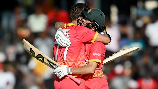 Craig Ervine of Zimbabwe celebrates reaching his century with teammate Sean Williams during the ICC Men's Cricket World Cup Qualifier Zimbabwe 2023 match between Zimbabwe and Nepal at Harare Sports Club on June 18, 2023 in Harare, Zimbabwe.