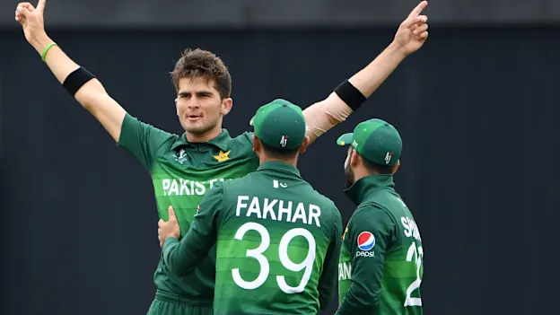 Pakistan's Shaheen Shah Afridi (L) celebrates with teammates Fakhar Zaman (C) and Shadab Khan