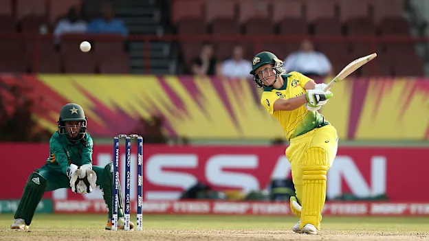 Alyssa Healy of Australia bats with Sidra Nawaz, wicket keeper of Pakistan looking on during the ICC Women's World T20 2018 match between Australia and Pakistan at Guyana National Stadium on November 9, 2018 in Providence, Guyana.