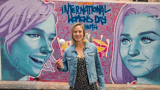 Ellyse Perry in front of finished mural