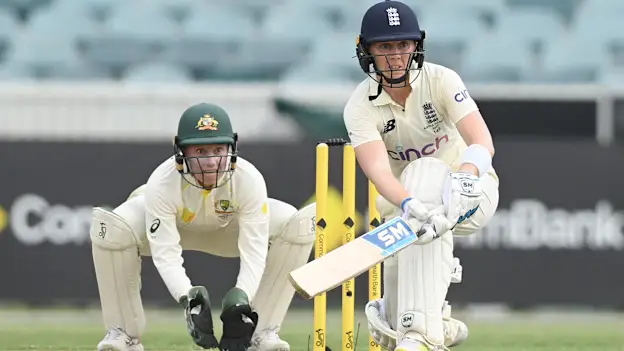 Heather Knight of England bats watched by Alyssa Healy of Australia during day two of the Women's Test match in the Ashes series between Australia and England at Manuka Oval
