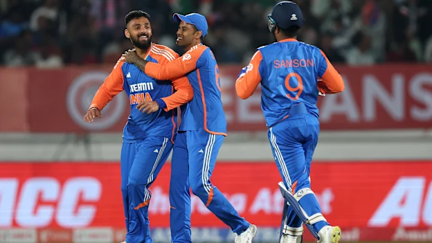 Varun Chakaravarthy celebrates with skipper Suryakumar Yadav