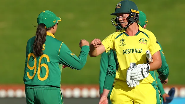 Meg Lanning of Australia is congratulated by Sune Luus of South Africa