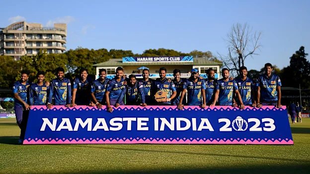 Dasun Shanaka lifts the trophy as players of Sri Lanka pose for a team photograph, as they celebrate after qualifiying for the ICC Men’s World Cup in India.