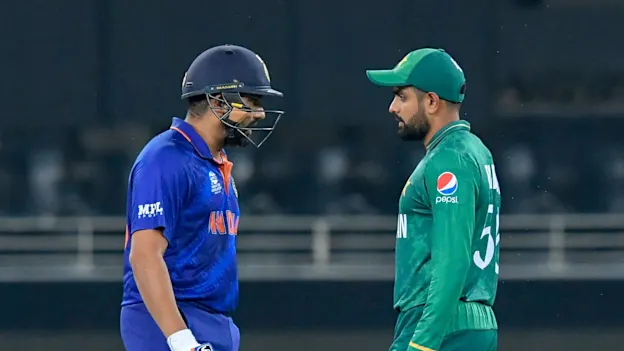 India's Rohit Sharma (L) walks past Pakistan's captain Babar Azam_1920x1080