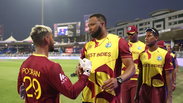 Nicholas Pooran and Kieron Pollard of West Indies interact following the ICC Men's T20 World Cup match between West Indies and Bangladesh at Sharjah Cricket Stadium on October 29, 2021 in Sharjah, United Arab Emirates.