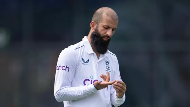 Moeen Ali of England examines his blistered finger during Day Three of the LV= Insurance Ashes 1st Test match between England and Australia