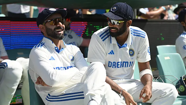 Virat Kohli and Jasprit Bumrah sharing a laugh in the dugout