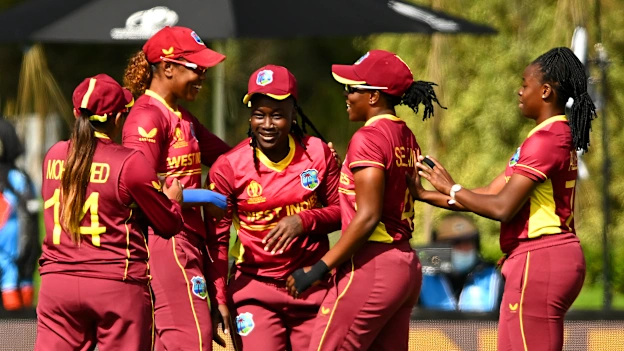 Deandra Dottin of West Indies is congratulated by team mates after catching out Lauren Winfield-Hill