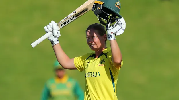 Meg Lanning of Australia raises her bat after scoring a century during the 2022 ICC Women's Cricket World Cup match between South Africa and Australia at Basin Reserve on March 22, 2022 in Wellington, New Zealand.
