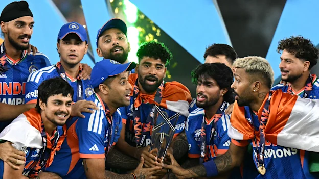 India's players celebrate with the trophy after winning the 2026 ICC Men's T20 Cricket World Cup final match against New Zealand
