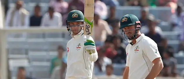 Peter Handscomb raising his bat after reaching his 50