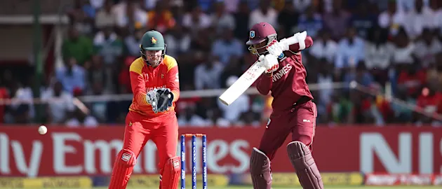Brendan Taylor of Zimbabwe looks on as Marlon Samuels of The Windies scores runs during The Cricket World Cup Qualifier between The Windies and Zimbabwe at The Harare Sports Club on March 19, 2018 in Harare, Zimbabwe (©ICC).