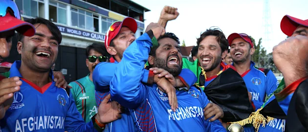 The winning Afghanistan team are lead in celebrations by Mohammed Shahzad (C) after The ICC Cricket World Cup Qualifier between Ireland and Afghanistan at The Harare Sports Club on March 23, 2018 in Harare, Zimbabwe (©ICC).