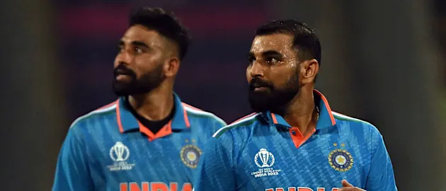 India's Mohammad Shami (R) and Mohammed Siraj look at the screen for replay after the dismissal of Sri Lanka's Dushan Hemantha
