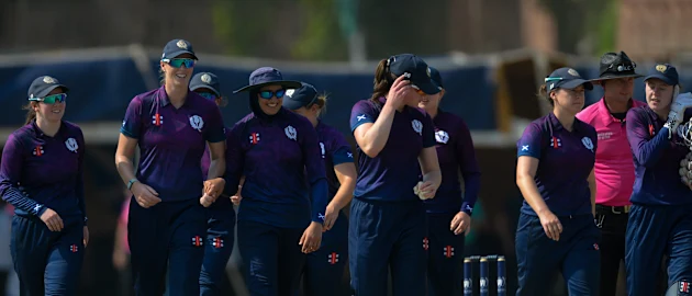 Scotland players celebrate after taking a wicket b