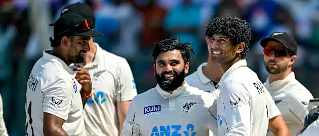 New Zealand's Ish Sodhi (L), Ajaz Patel (2L) and Rachin Ravindra (2R) celebrate after their team's win against India at the end of their third and final Test cricket match in the Wankhede Stadium of Mumbai