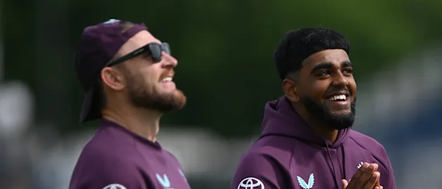 England bowler Rehan Ahmed and coach Brendon McCullum smile during nets