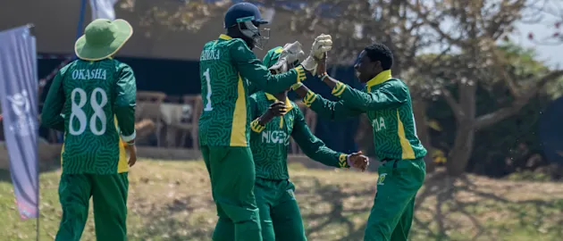 120826 Nigeria Vs Rwanda-Nigeria players join Kenneth Boniface(far right) after picking a wicket